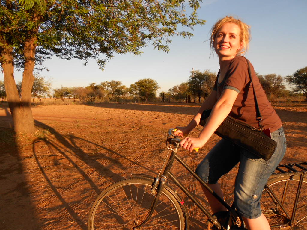 Marlene Verwey riding a bicycle on a Kalahari farm